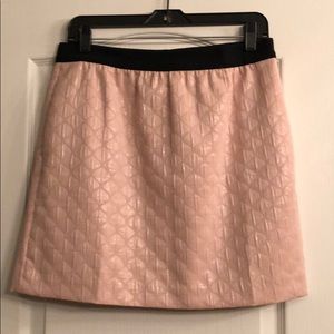 Peach skirt with metallic inlets.